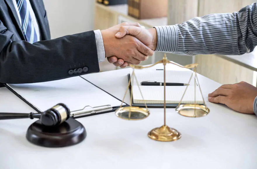 mediation professional and client shaking hands